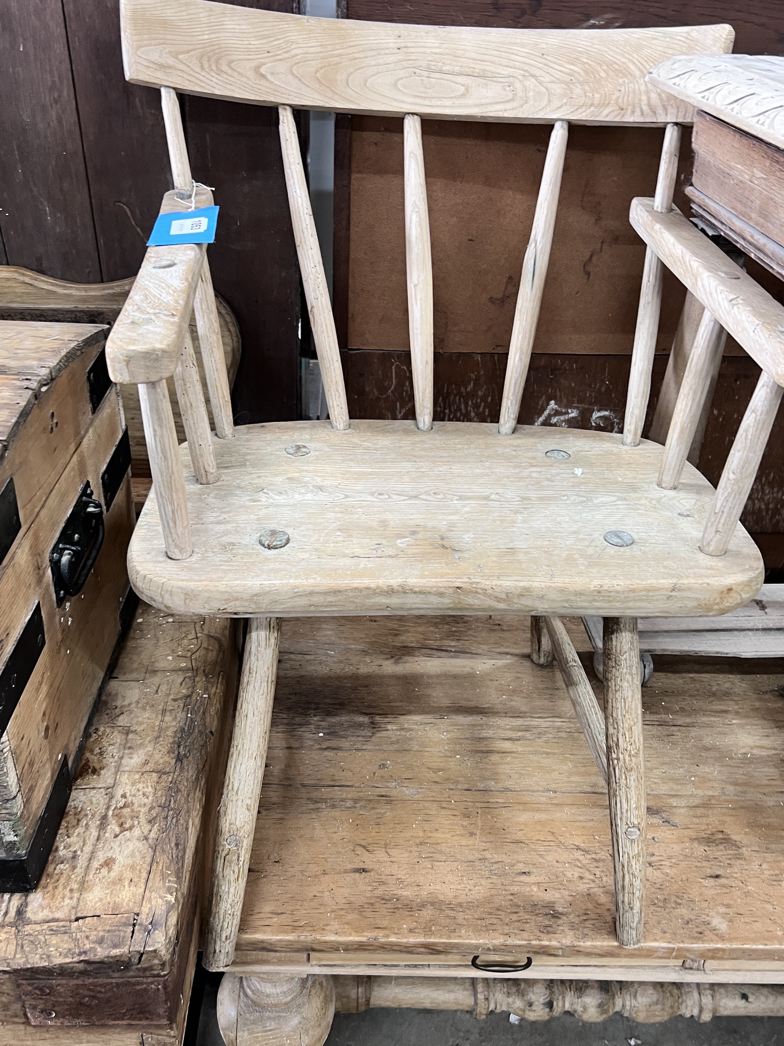 An early 19th century primitive pine comb back elbow chair, width 64cm, depth 57cm, height 81cm